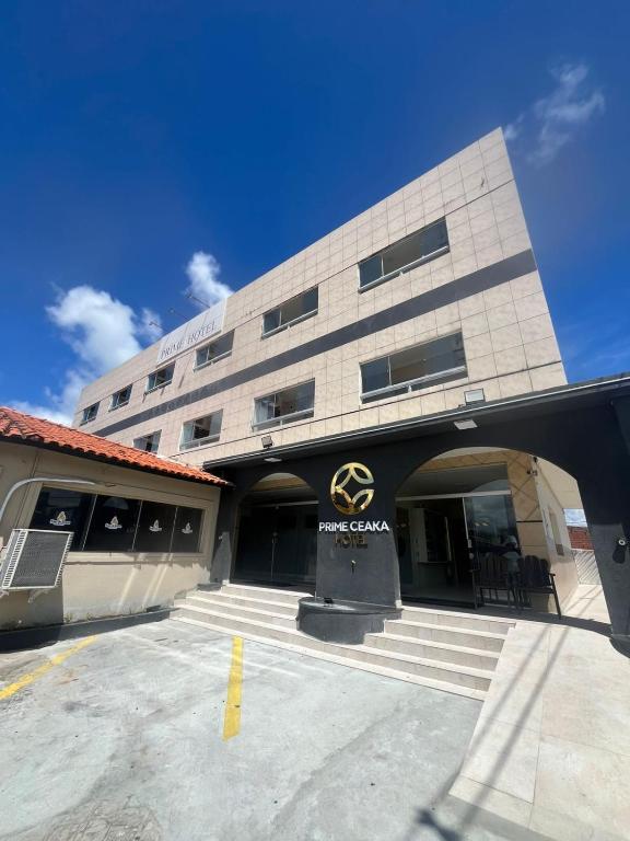 a building with a sign on the front of it at Hotel Prime Ceaka in Caruaru