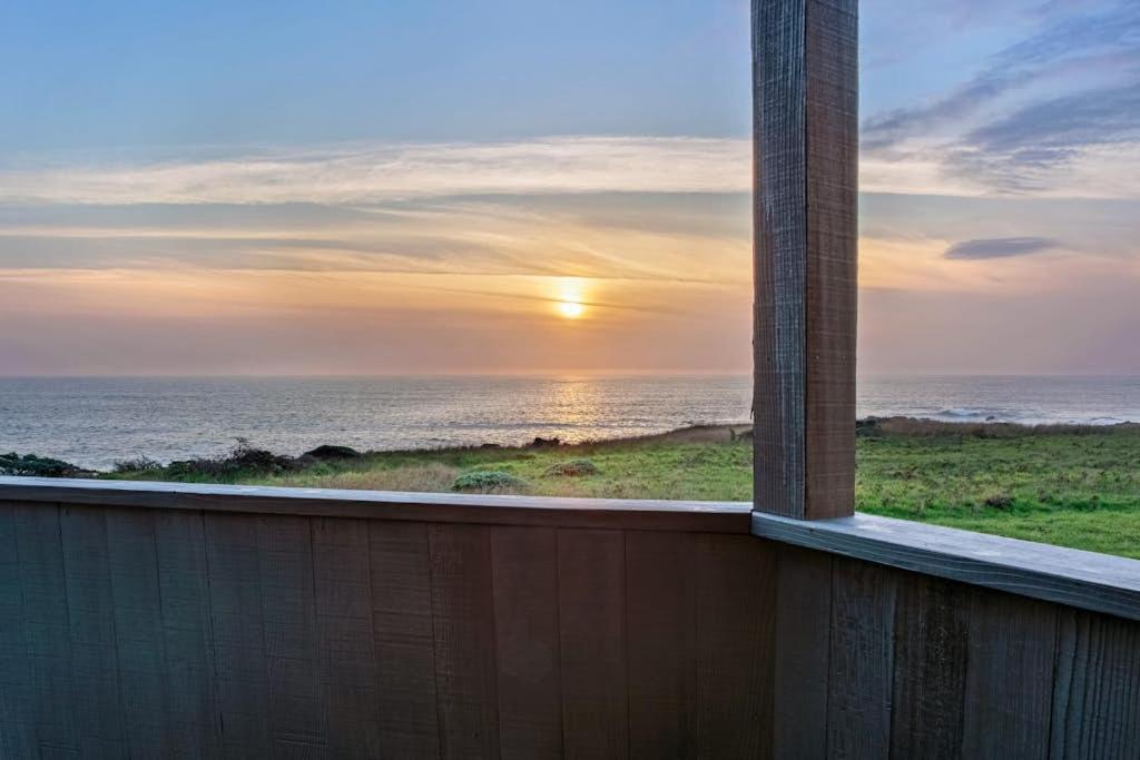 a sunset over the ocean from a building with a chimney at Casa Pelo Mar in Sea Ranch