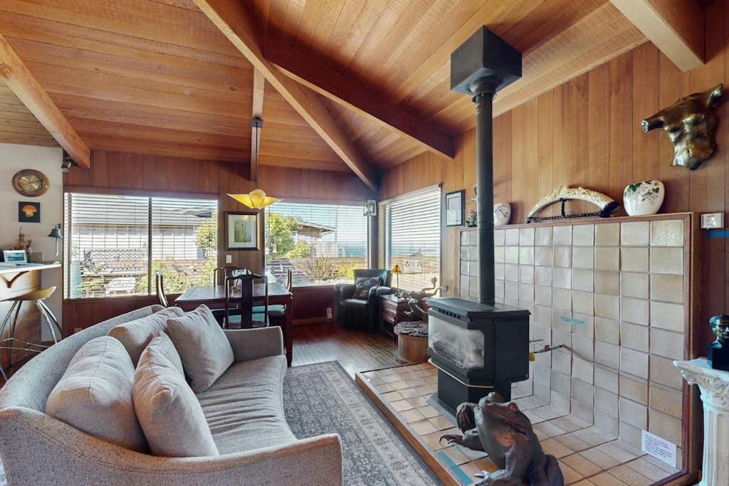 a living room with a couch and a fireplace at Nature's Paradise in Gualala