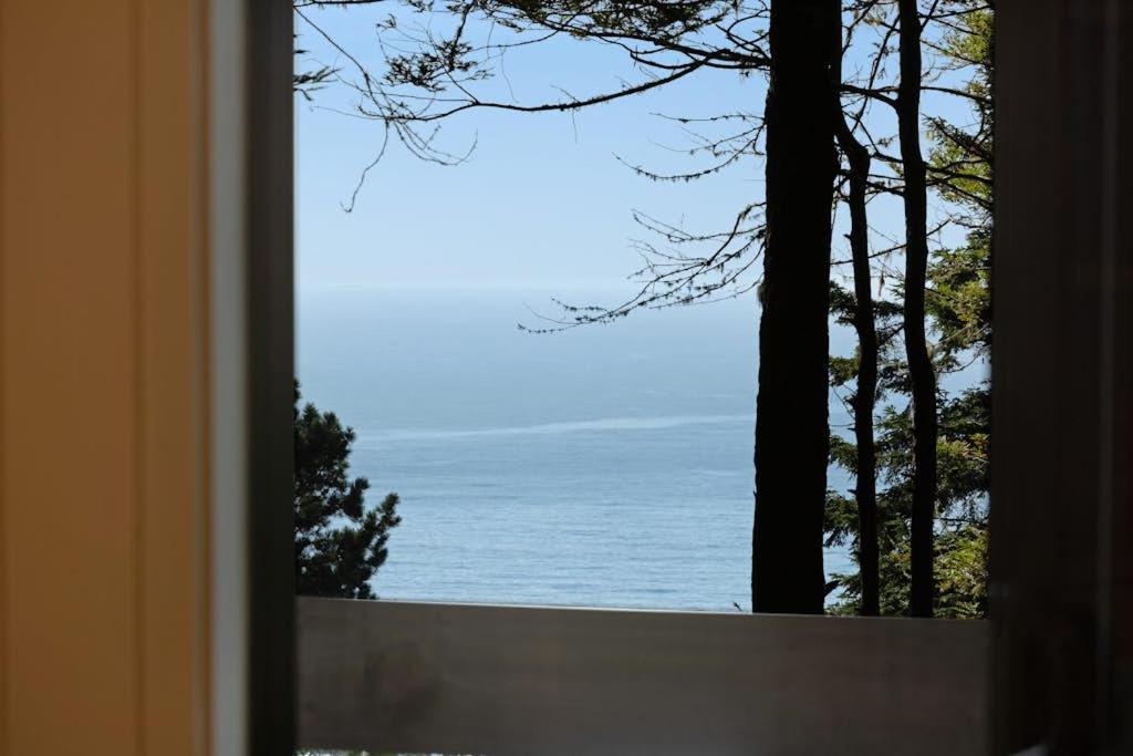 a view of the ocean from a window at Tree House in Sea Ranch