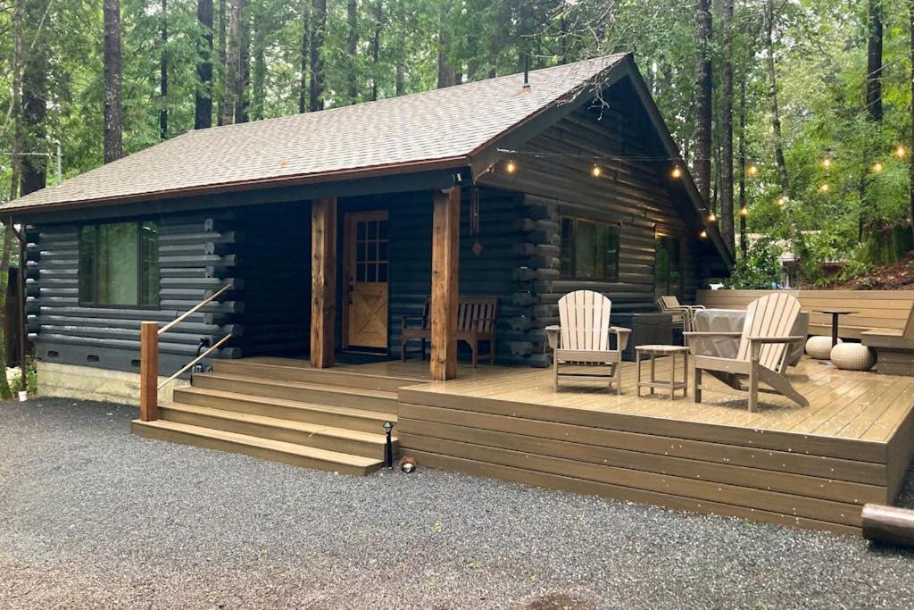 a log cabin with two chairs and a table at Cabin Fever in Gualala