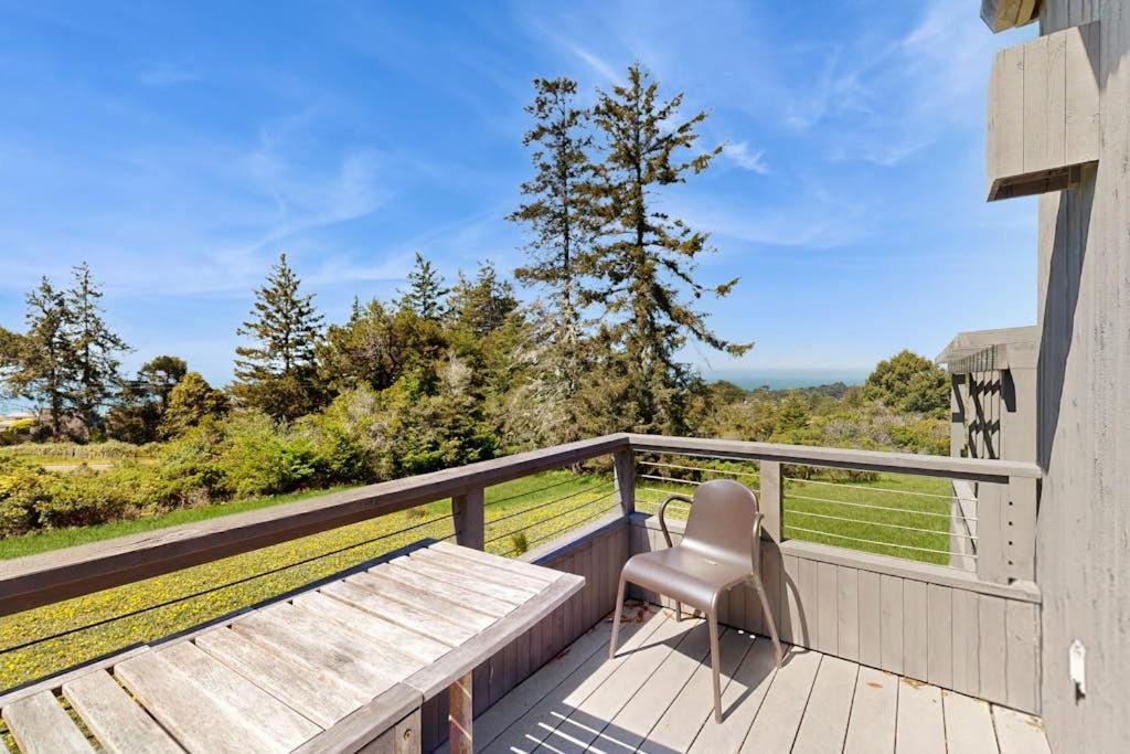 a chair sitting on a balcony with a bench at Footloose in Sea Ranch