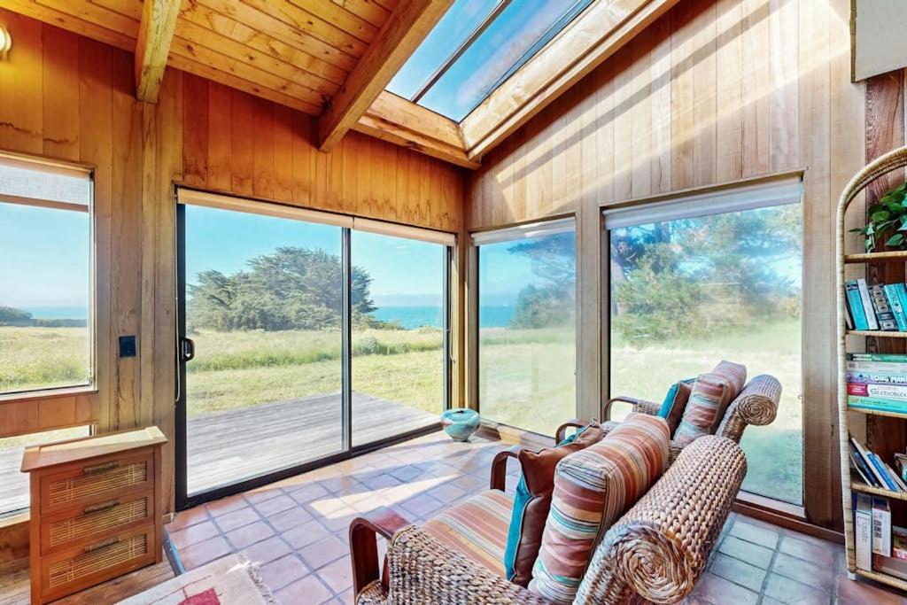 a living room with two couches and large windows at Albatross Reach in Sea Ranch