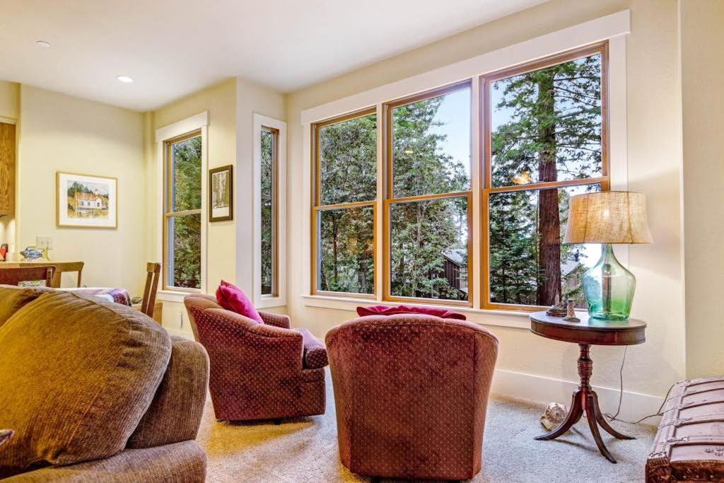 a living room with two chairs and two windows at Spyglass View in Sea Ranch