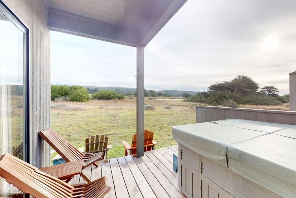 a patio with two chairs and a table on a deck at Whispering Wave in Gualala