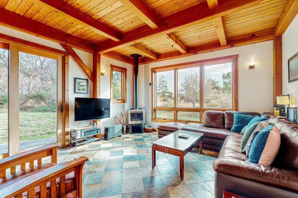 a living room with a couch and a tv at The Barn in Gualala