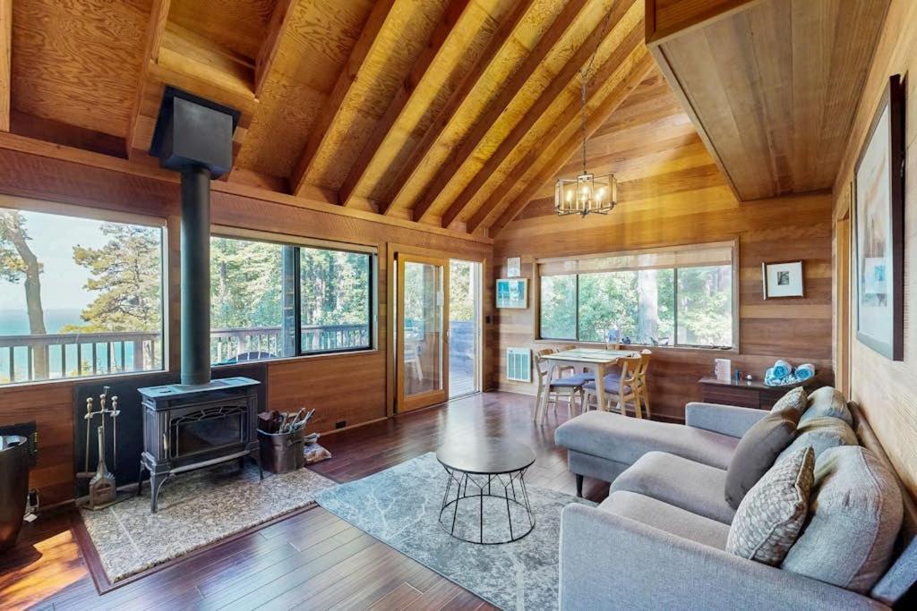 a living room with a couch and a fireplace at Redwood Grove in Sea Ranch