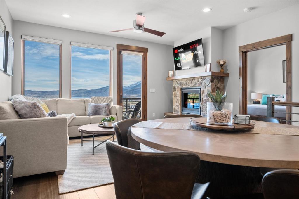 a living room with a table and a fireplace at Moose Ridge Hideaway Ri903 Ski Retreat Hot Tub in Eden