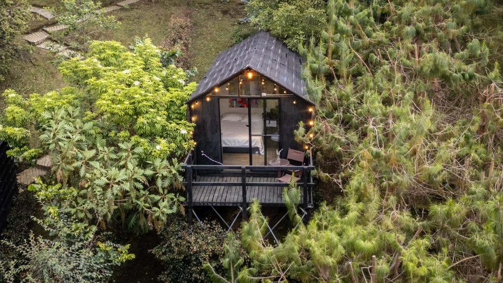 an aerial view of a tiny house with lights at Tiny House La Silleta in Medellín
