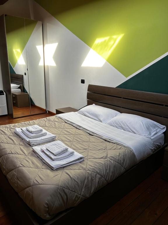 a bedroom with a bed with towels on it at Appartamento Il Loftino in Forlì