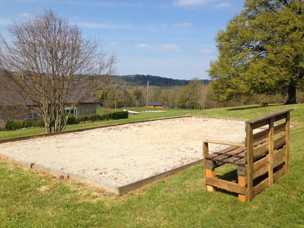 a large sand pit in the middle of a field at Maison Chabrat in Liginiac