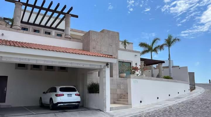 a white car parked outside of a house at Increible Casa con vista al mar in La Paz