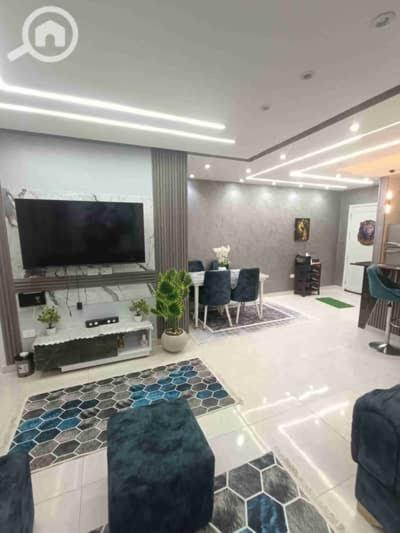 a living room with a flat screen tv on a wall at دوبلكس شرق in Madīnat ash Shurūq