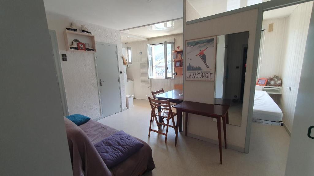 a living room with a couch and a table in a room at appartement 4 places centre-ville in Cauterets