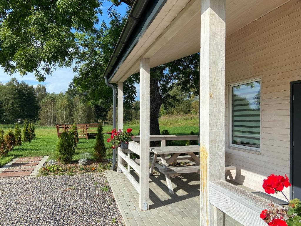 a porch of a house with a picnic table at Motel Level 2 in Miastko