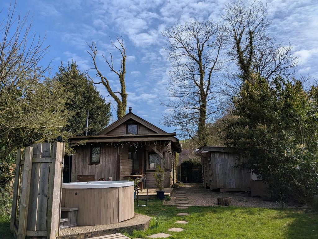 a small house with a bath tub in the yard at Cosy Eco Cabin in Newport