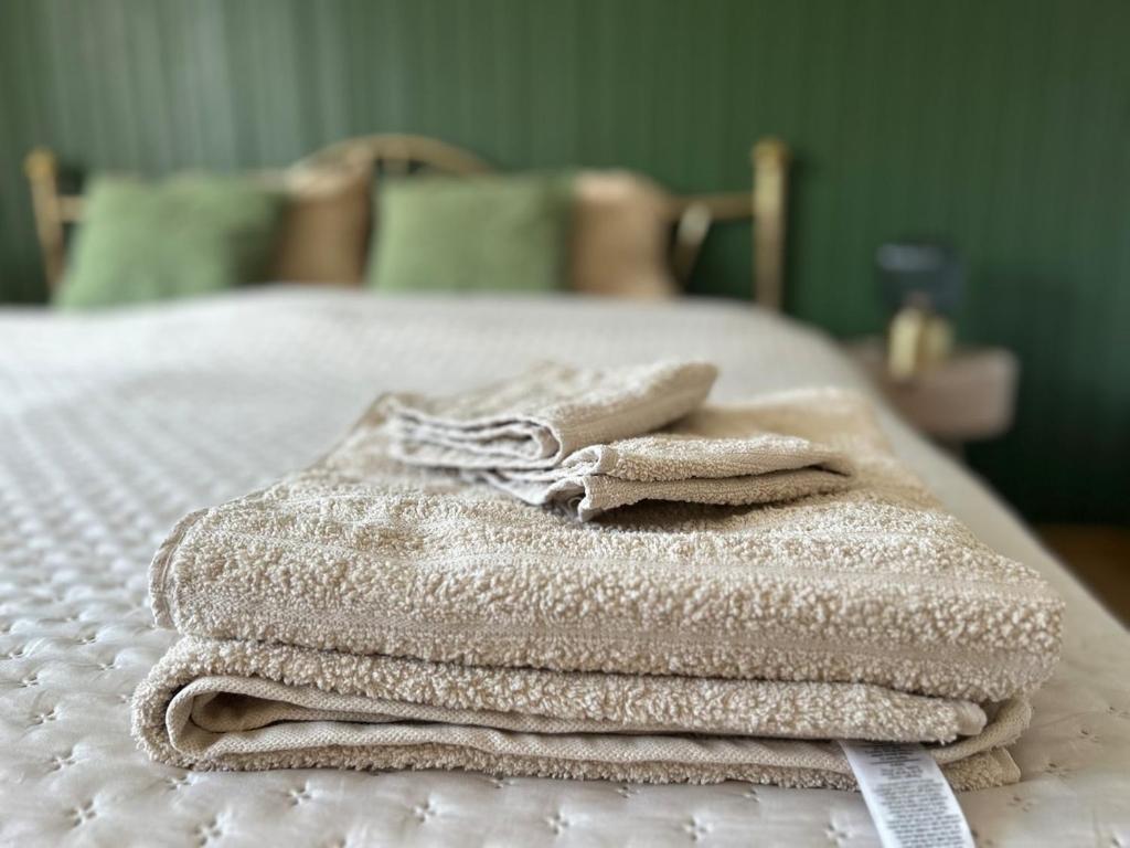 a pile of towels sitting on top of a bed at Apartma Prospera - free parking in Maribor