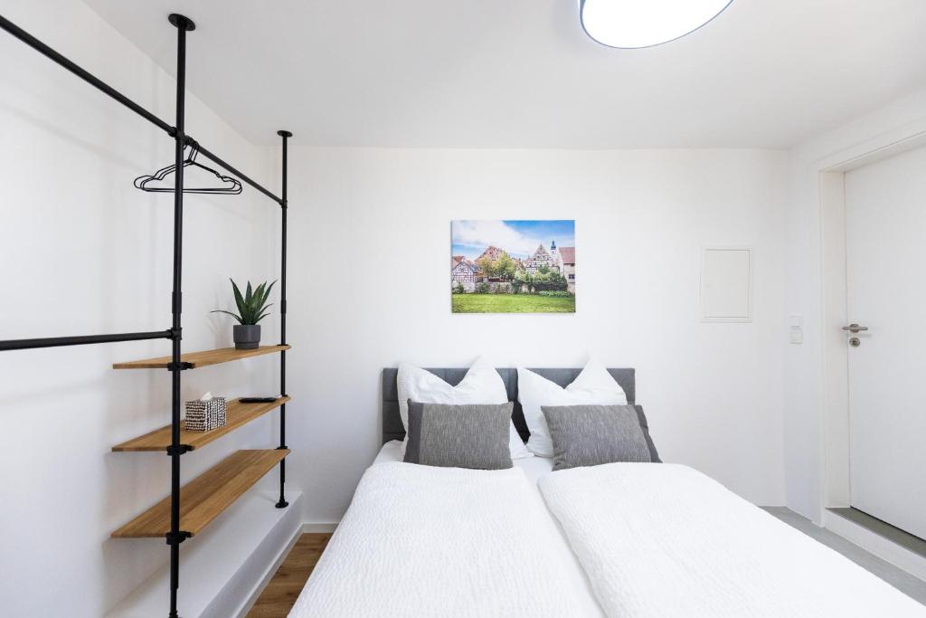 two beds in a bedroom with white walls at Appartement im Weiherhaus in Forchheim