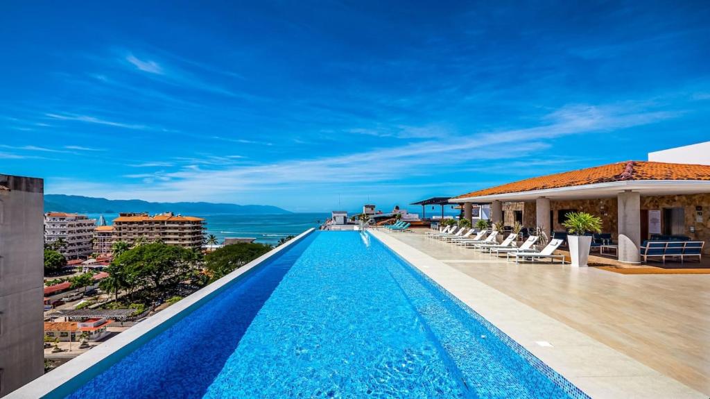 a pool on the roof of a building with a view at Penthouse Oceanview 1 block Malecon bars shops ZR in Puerto Vallarta