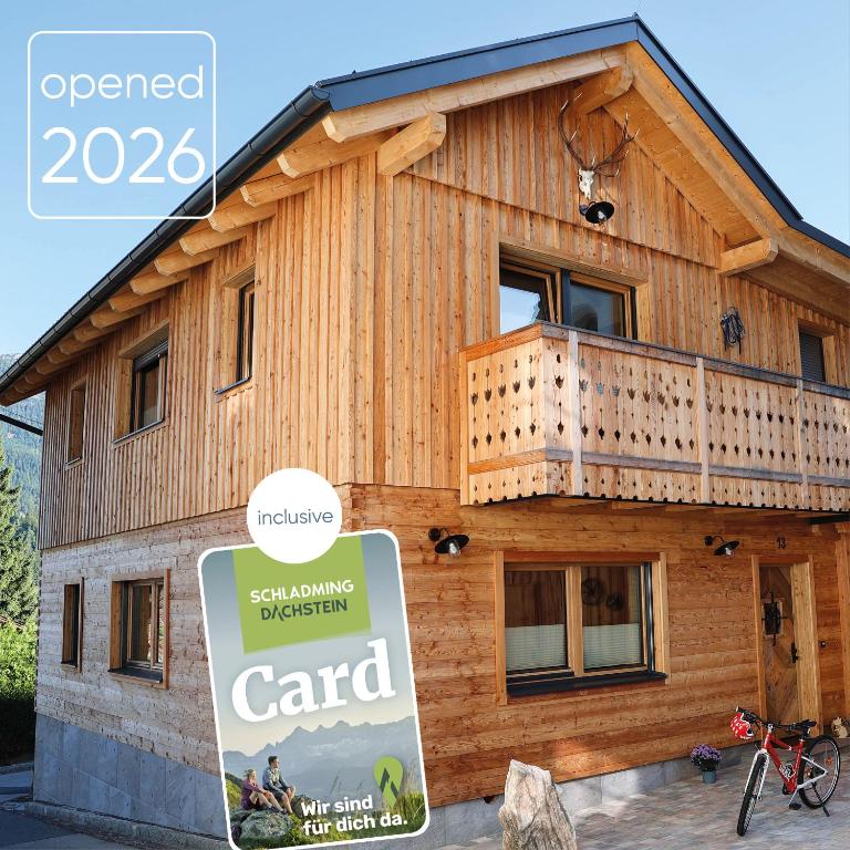 a wooden house with a sign in front of it at Chalet Gipfelsturm in Haus im Ennstal