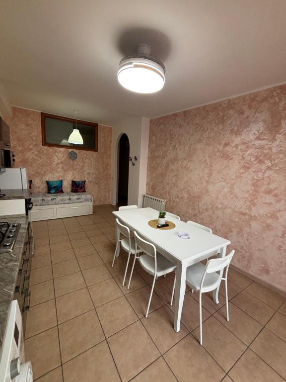 a dining room with a white table and chairs at Ludovica's house 2 in Giardini Naxos