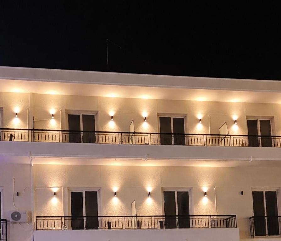 a white building with lights on the side of it at Mézzo Lago in Missolonghi