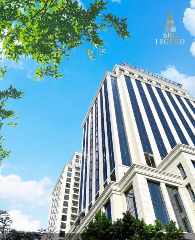 a tall white building with a blue sky in the background at BRG Luxury Apartments in Hai Phong