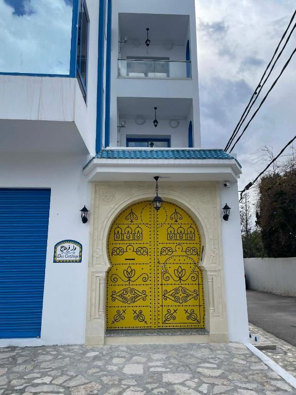 a yellow door on the side of a building at Dar Carthage Hergla in Harqalah