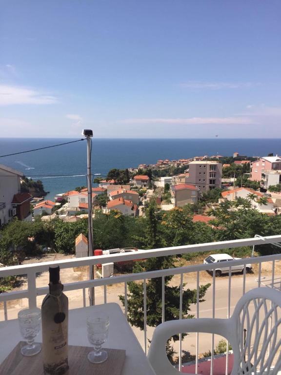 a bottle of wine sitting on a table on a balcony at New Apartments Blue in Ulcinj