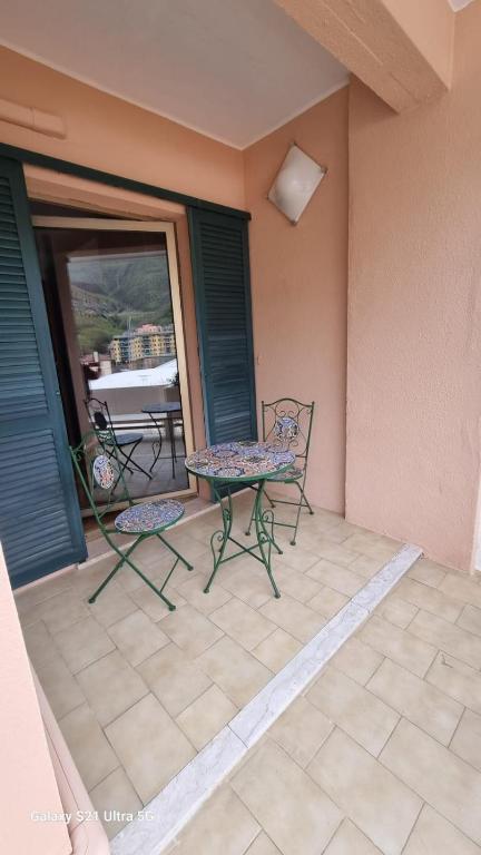 a patio with two chairs and a table and a window at Casa Luisa in Recco