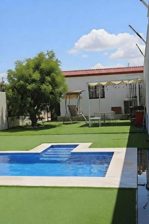 a swimming pool in the yard of a house at شاليه ياسمين حتا الخاص - Jasmin Hatta Private Chalet in Hatta