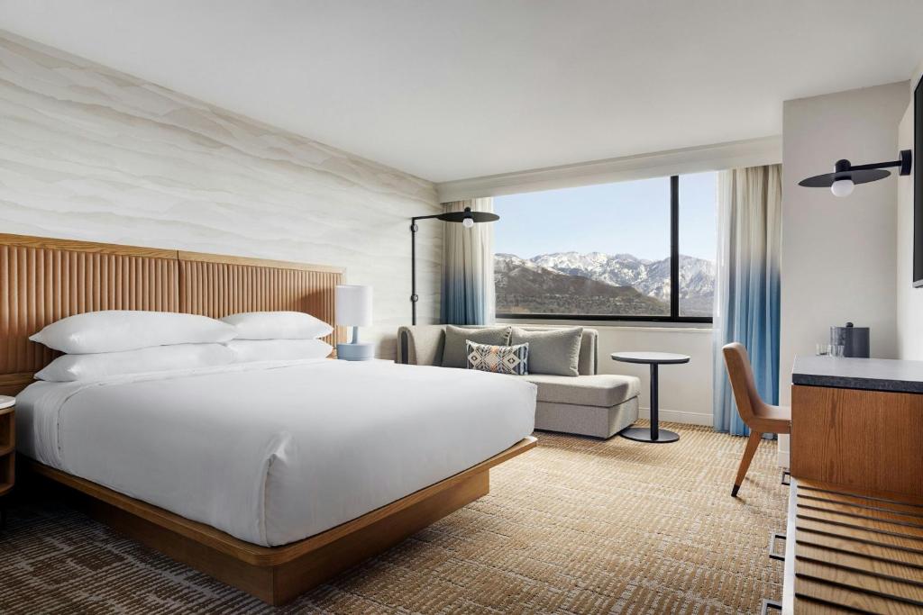 a bedroom with a large white bed and a couch at Salt Lake City Marriott University Park in Salt Lake City