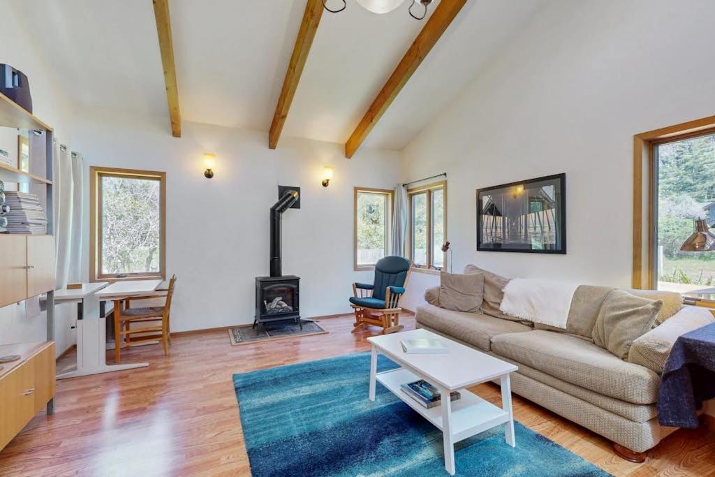 a living room with a couch and a table at Loon's Landing in Sea Ranch