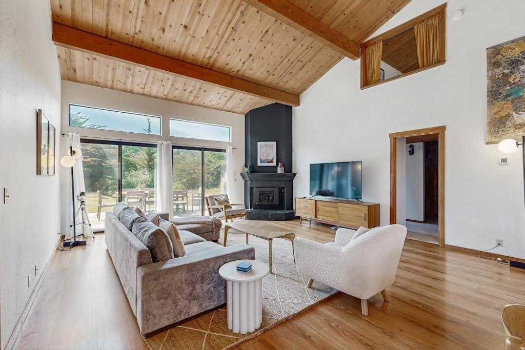 a living room with a couch and a fireplace at Hilma House in Sea Ranch