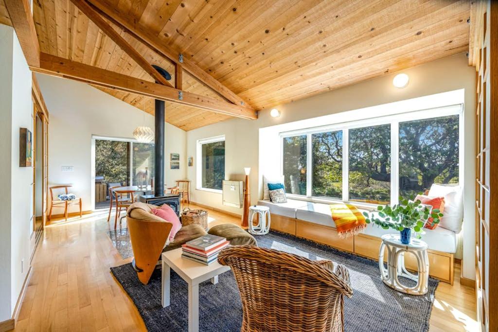 a living room with a couch and a table at Madrone Cottage in Sea Ranch