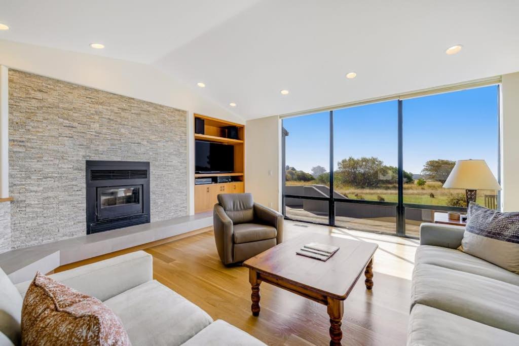 a living room with a couch and a fireplace at Heron's Nest in Sea Ranch