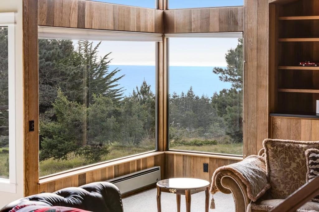a living room with a large window with a view at Greencroft Meadows in Sea Ranch