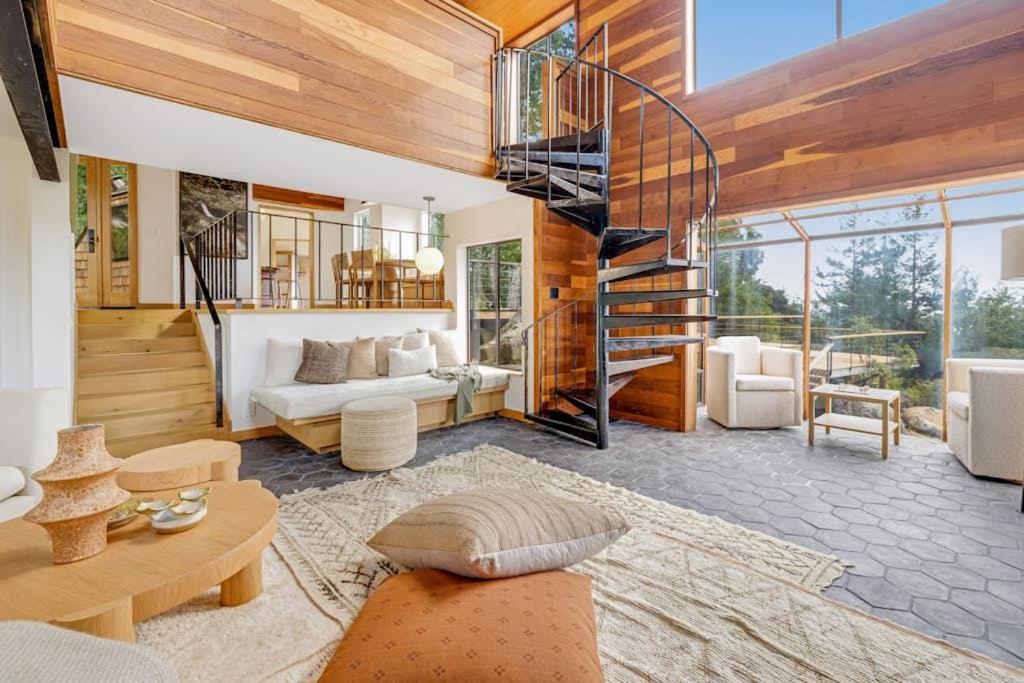 a living room with a spiral staircase in a house at Sequoia Vista in Gualala