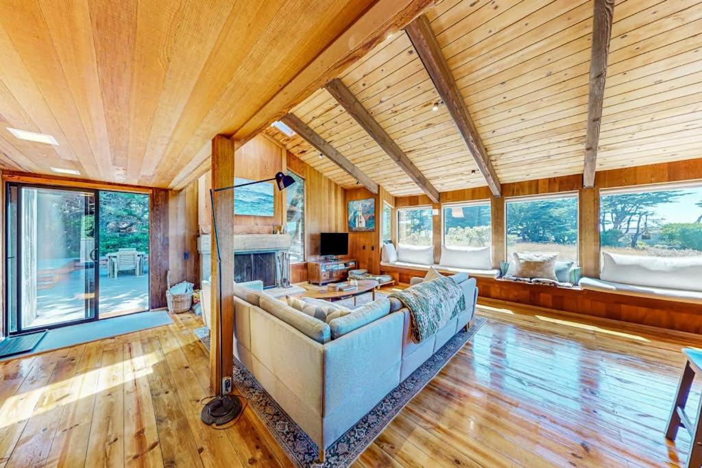 a large living room with a couch and a fireplace at Dune Drift in Sea Ranch