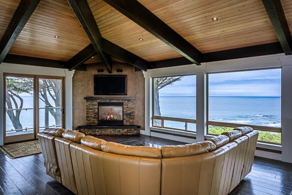 a living room with a couch and a fireplace at Oceanfront Dream Hideaway in Gualala