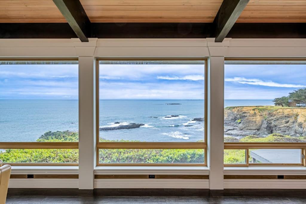 a room with three windows looking out at the ocean at Oceanfront Dream Hideaway and Retreat in Gualala