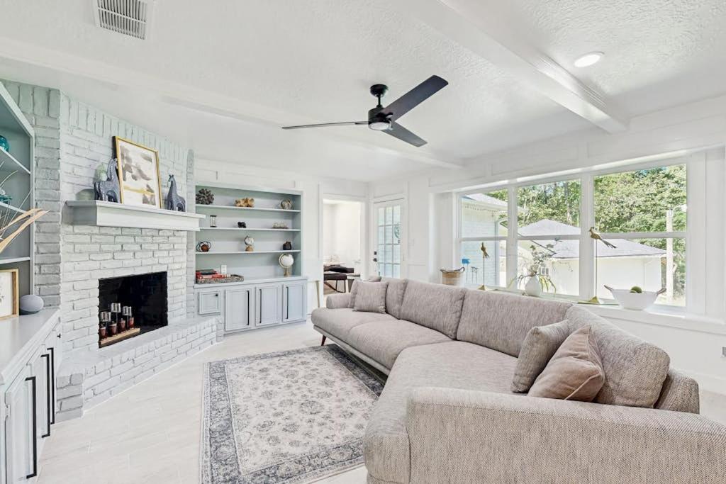 a living room with a couch and a fireplace at Lake Grove Retreat in Conroe