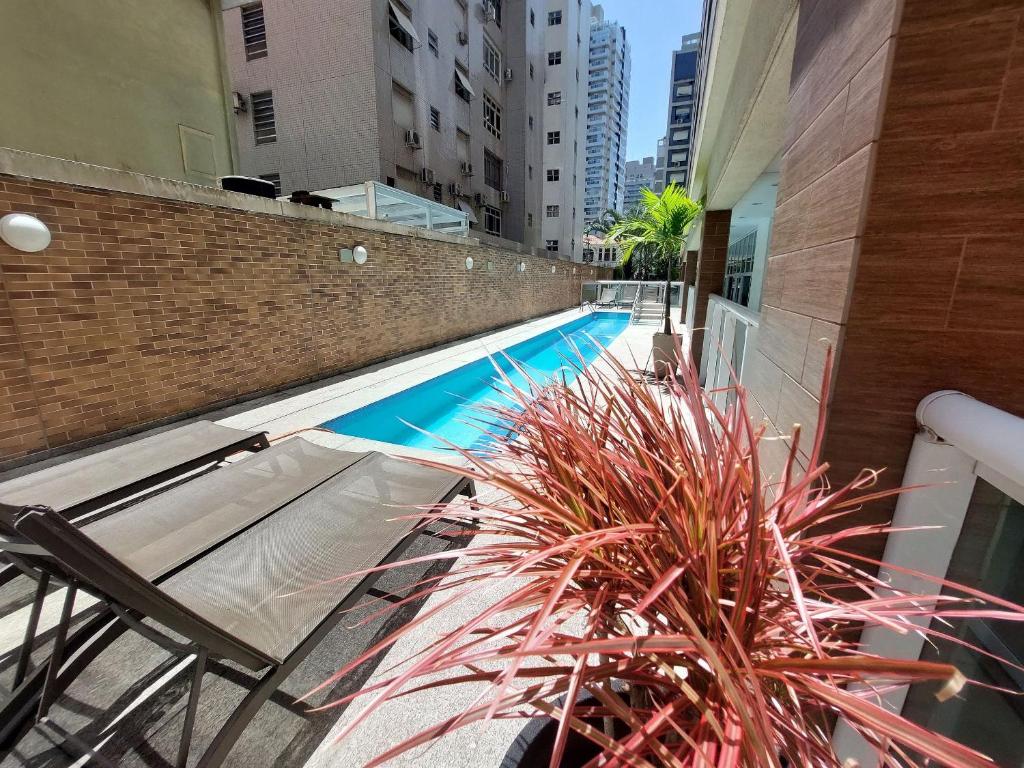 a view of a swimming pool in a building at Book Santos Mar, Sol e Conforto no Unique 710 e 810 in Santos