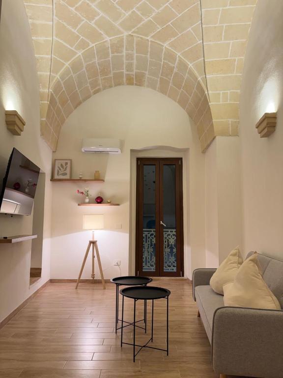 a living room with a couch and a table at SUITE LUX apulia in Massafra