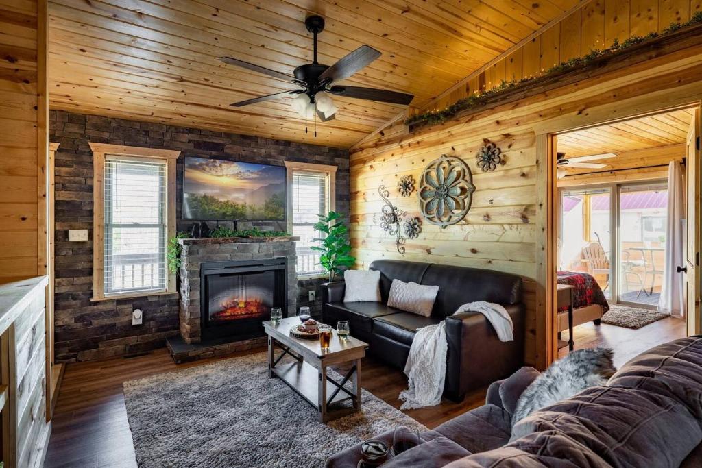 a living room with a couch and a fireplace at Firefly Cabin in Pigeon Forge