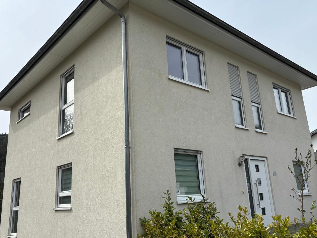 a tan building with windows and a street light at Entspannung am Wald in Wald-Michelbach