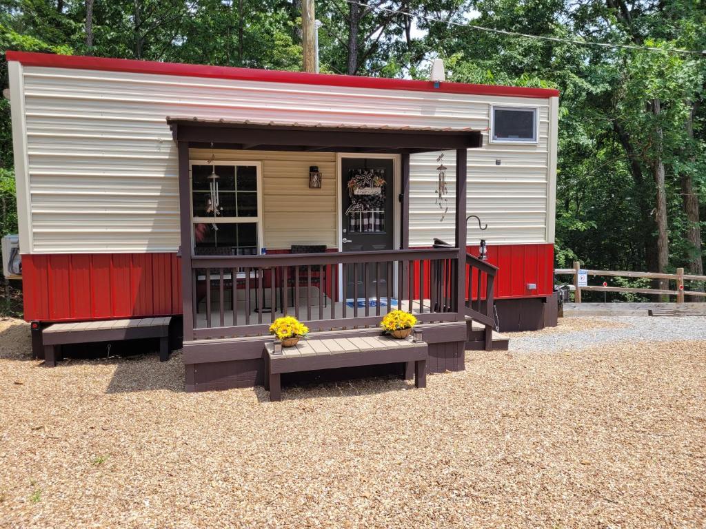 a tiny house with a bench in front of it at The Tiny House at Deer Holler in Sugar Tree