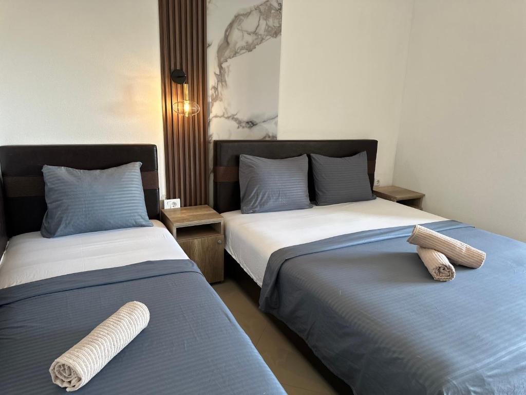 two beds sitting next to each other in a room at STANDART Premium in Ulcinj