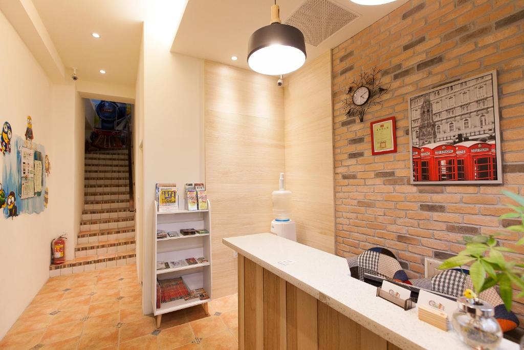 a kitchen with a brick wall and a sink at Zi Jing Cheng B&B in Hualien City