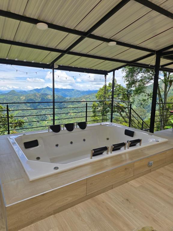 a large white tub in a room with a view at Finca La Tranquilidad in San Francisco